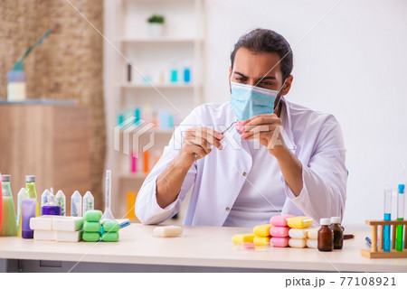 Young male chemist testing soap in the lab 77108921