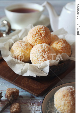 Coconut flakes cookies and cup of tea Coconut flakes cookies and cup of tea 77109095