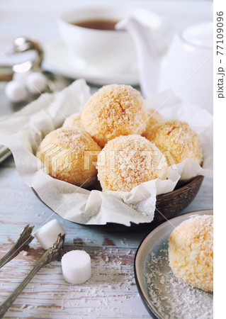 Coconut flakes cookies and cup of tea Coconut flakes cookies and cup of tea 77109096