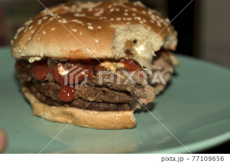 Triple meat delicious burger on a blue plate Triple meat delicious burger on a blue plate 77109656