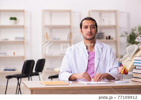 Young male doctor student cardiologist sitting in the classroom 77109912