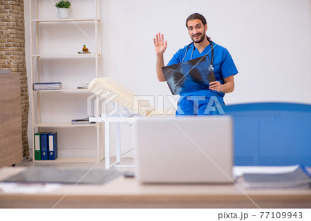 Young male doctor radiologist working in the clinic Young male doctor radiologist working in the clinic 77109943