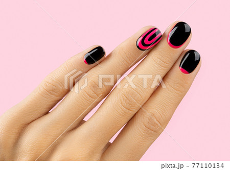 Beautiful groomed womans hand with trendy manicure on pink background 77110134