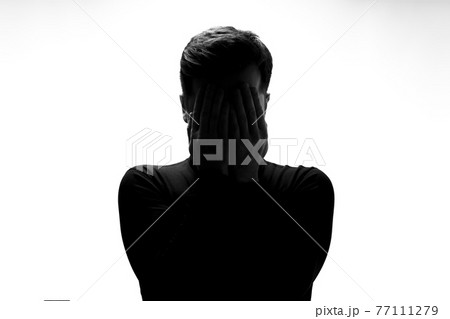 Silhouette of man crying being sad having depression 77111279