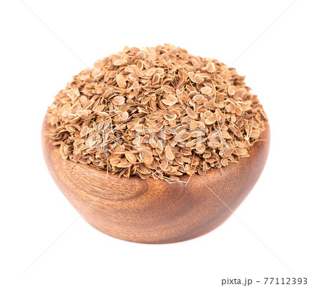 Dill seeds in wooden bowl, isolated on white background. Natural dry dill seeds. Anethum graveolens. Dill seeds in wooden bowl, isolated on white background. Natural dry dill seeds. Anethum graveolens. 77112393