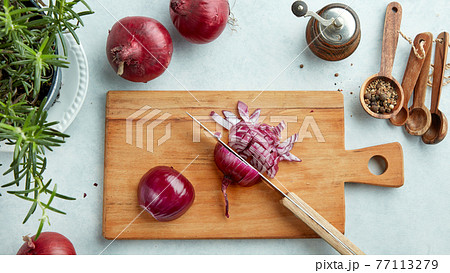 chopped red onions on wooden cutting board chopped red onions on wooden cutting board 77113279