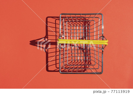 steel supermarket basket with hard shadow on colored background 77113919
