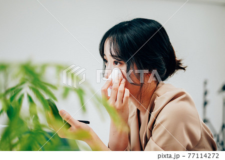 笑顔でメイクをする若い女性 笑顔でメイクをする若い女性 77114272