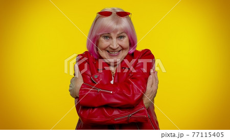 Mature old granny grandmother spread hands and give hug to you, pleasant expression, love feelings Mature old granny grandmother spread hands and give hug to you, pleasant expression, love feelings 77115405