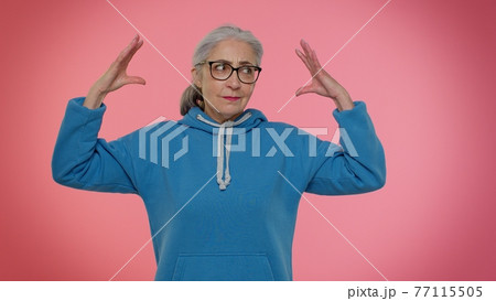 Elderly granny woman showing nonsense gesture with hands, gossips, empty promises, lier concept Elderly granny woman showing nonsense gesture with hands, gossips, empty promises, lier concept 77115505