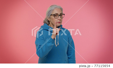 Senior old woman shakes finger and saying no, be careful, avoid danger mistake, disapproval sign Senior old woman shakes finger and saying no, be careful, avoid danger mistake, disapproval sign 77115654