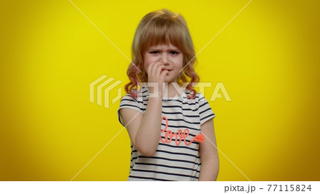 Little teen child kid girl closing eyes with hand showing stop gesture, confused shy scared to watch Little teen child kid girl closing eyes with hand showing stop gesture, confused shy scared to watch 77115824