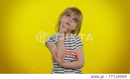 Doubting pensive little child kid girl wondering difficult solution, feeling confused about choice 77116009