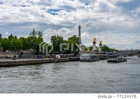 The Seine river and Eiffel Tower under summer blue sky The Seine river and Eiffel Tower under summer blue sky 77124376