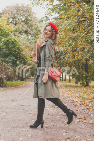 Autumn portrait of happy beautiful woman in red french beret and handbag outdoor 77124640