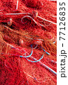 Red fishing nets with floats and ropes. Close-up shot, perfect image for fishing, aquaculture and environmental protection. 77126835