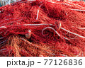 Red fishing nets with floats and ropes. Still-life shot, perfect image for fishing, aquaculture, intensive fishing and environmental protection. 77126836