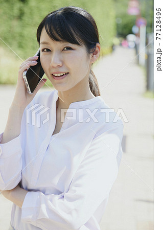 Woman with cell phone, city. Woman with cell phone, city. 77128496