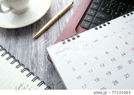 January month on calendar on office desk 77131063