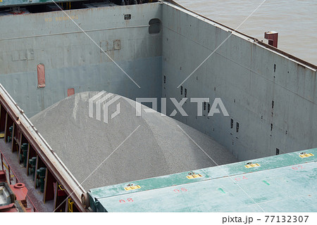 Cargo hold of bulk carrier ship full of bulk cargo. 77132307