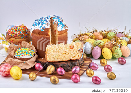 Easter cake and painted eggs on the white table. Easter cake and painted eggs on the white table. 77136010