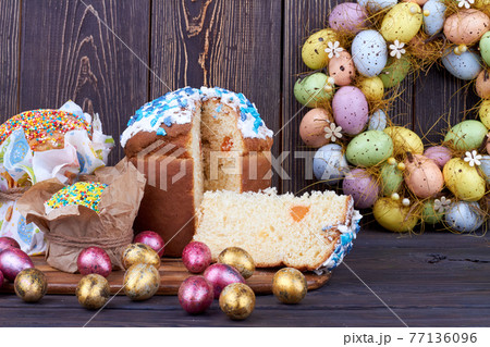 Sweet cupcake with cut slice on dark wooden background. Sweet cupcake with cut slice on dark wooden background. 77136096