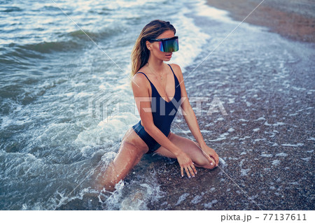 portrait of beautiful sexy Caucasian sunbathed woman in sunglasses 77137611