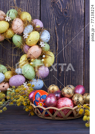 Colored easter eggs and yellow willow branch. Colored easter eggs and yellow willow branch. 77138224