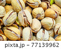 Raw salted pistachios nuts, top down view. Macro shot, perfect for vegan diet and healthy eating. 77139962