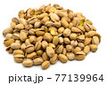 A set of salted and roasted pistachio seeds on a white background. Perfect shot for vegan diet, wellness and healthy eating. 77139964
