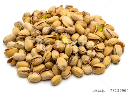 A set of salted and roasted pistachio seeds on a white background. Perfect shot for vegan diet, wellness and healthy eating. 77139964