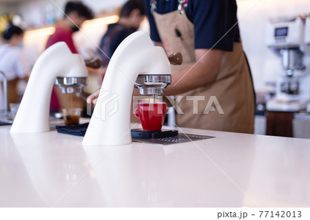 Flair espresso machine in a coffee shop with barista. Flair espresso machine in a coffee shop with barista. 77142013