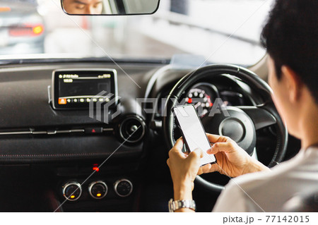 Irresponsible man using smart phone while driving. Irresponsible man using smart phone while driving. 77142015