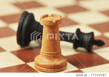 wooden chess pieces on a chessboard wooden chess pieces on a chessboard 77143587