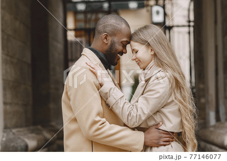 Mixed couple spenting time together in a spring city Mixed couple spenting time together in a spring city 77146077