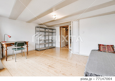 Spacious study room with table and shelves Spacious study room with table and shelves 77147064