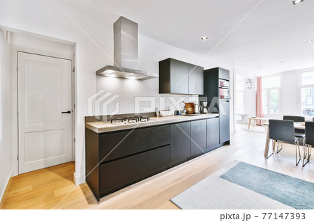 Modern kitchen with dining area 77147393