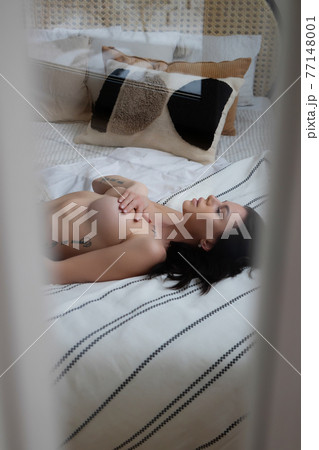 Sensual woman touching naked breast in bedroom Sensual woman touching naked breast in bedroom 77148001