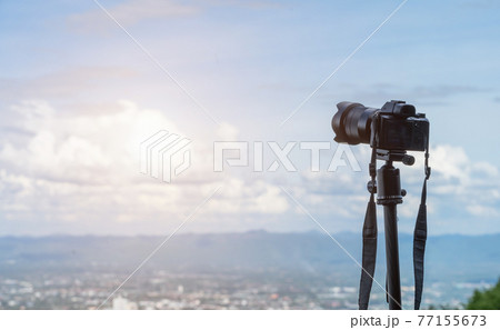 Mirrorless Camera capturing on admiring the view cityscape mountain range over the city air atmosphere bright blue sky background,Mirrorless on Tripod. 77155673