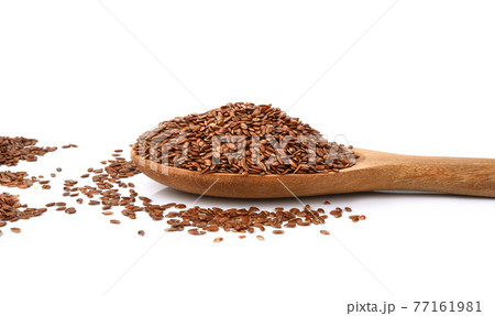 Flax seeds in a wooden spoon isolated on white background. 77161981