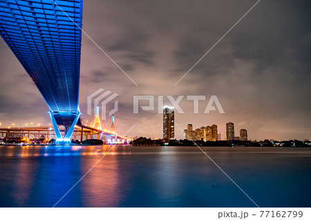 Purple led light under the bridge over the river On a cloudy day in the sky. Bhumibol Bridge, Samut Prakan, Thailand Purple led light under the bridge over the river On a cloudy day in the sky. Bhumibol Bridge, Samut Prakan, Thailand 77162799