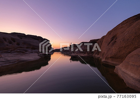 Sam Phan Bok, Ubon Ratchathani, Thailand. Dry rock reef in the Mekong River with mountain hills. Nature landscape background. Grand Canyon of Thailand. Sam Phan Bok, Ubon Ratchathani, Thailand. Dry rock reef in the Mekong River with mountain hills. Nature landscape background. Grand Canyon of Thailand. 77163095