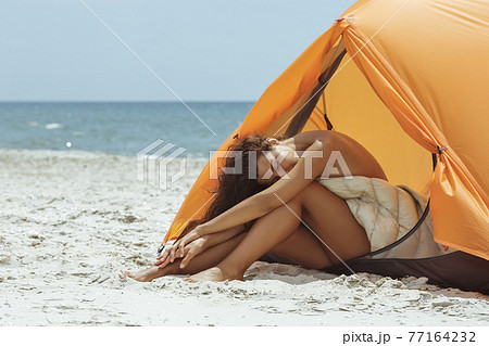 Naked Woman on the Beach in a Tent 77164232