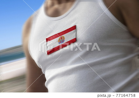 The national flag of French Polynesia on the athlete's chest The national flag of French Polynesia on the athlete's chest 77164758