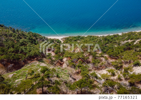 Aerial view of coastline with blue sea and highest cliff. Summer day on Black sea Aerial view of coastline with blue sea and highest cliff. Summer day on Black sea 77165321