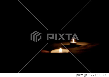Burning candle on the table in honor of Memorial Day 77165953