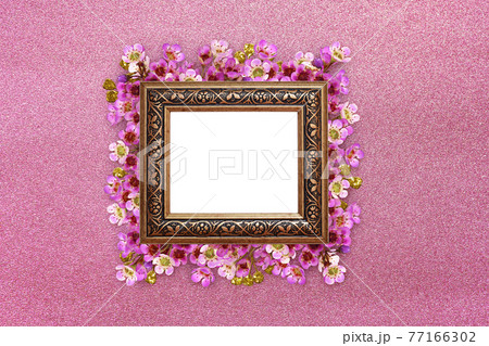 Pink chamelaucium flowers ana square bronze frame on pink textured paper 77166302