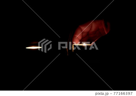 A candle is lit in memory of the victims. 77166397