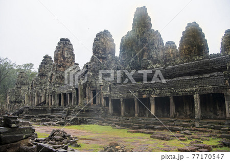 Bayon the central temple of Angkor Thom, late 12th century. It rains in the rainy season. (Cambodia, 04.10. 2019) Bayon the central temple of Angkor Thom, late 12th century. It rains in the rainy season. (Cambodia, 04.10. 2019) 77170547