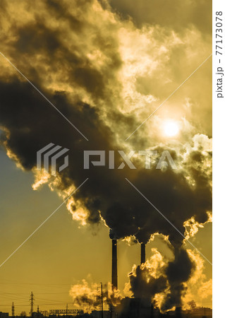 Sunset over the industrial city.Factory chimneys smoke.Environmental problem of environmental and atmospheric pollution.Climate change,environmental disaster.The sky is smoky with toxic substances CO2 Sunset over the industrial city.Factory chimneys smoke.Environmental problem of environmental and atmospheric pollution.Climate change,environmental disaster.The sky is smoky with toxic substances CO2 77173078